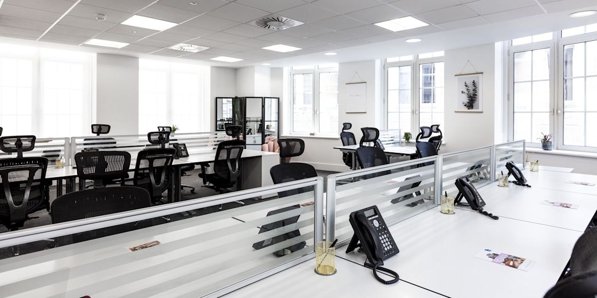 Modern open-plan office with rows of desks and chairs at 46 New Broad Street, London.