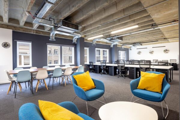 Modern open-plan office space with chairs, desks, and exposed ceiling at New Street 14, London.