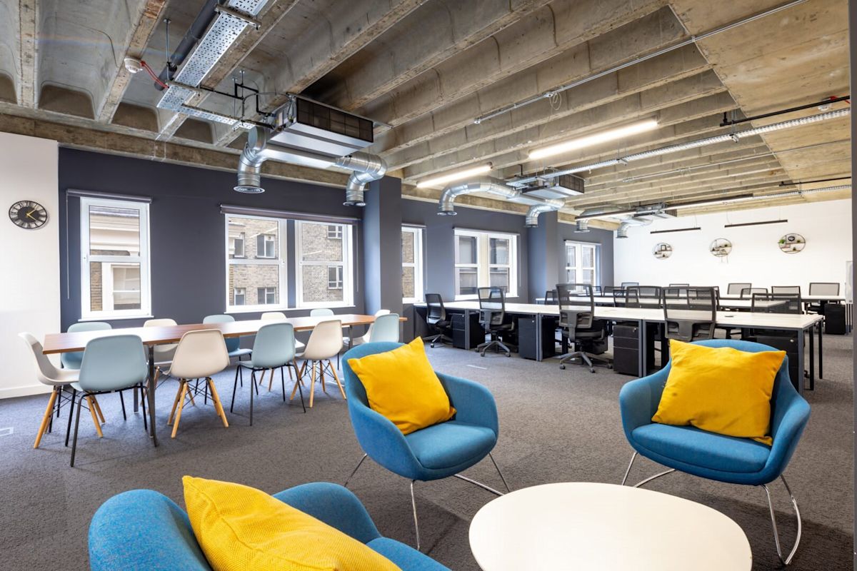 Modern open-plan office space with chairs, desks, and exposed ceiling at New Street 14, London.