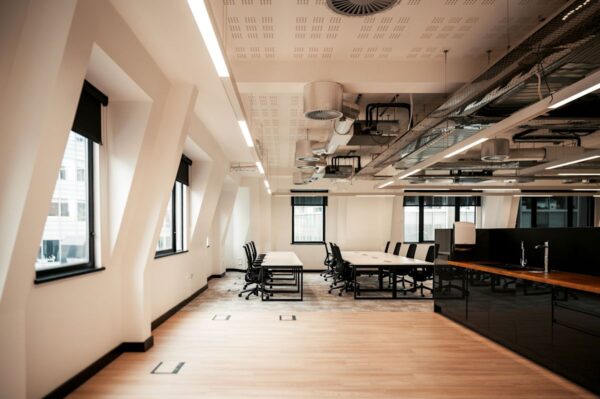 A modern, spacious office with large windows and sleek furniture at Norton Folgate 1 in London.