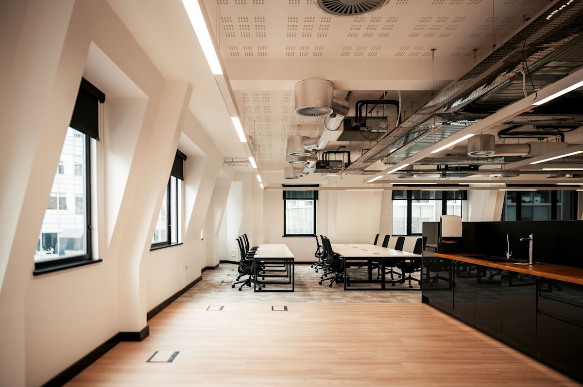 A modern, spacious office with large windows and sleek furniture at Norton Folgate 1 in London.