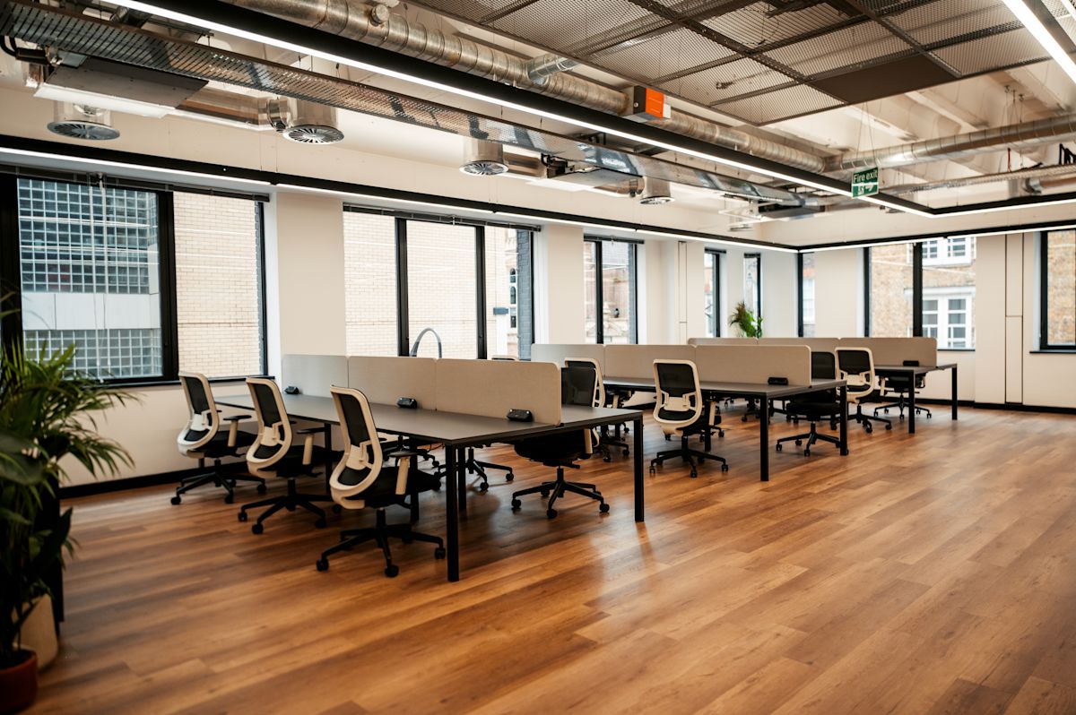 Modern open-plan office space with desks and chairs in Norton Folgate, London.