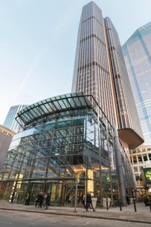 Tall modern skyscraper with a glass entrance on Old Broad Street 25 in London.