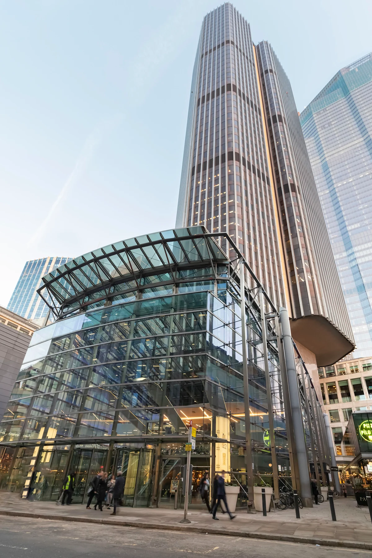 Tall modern skyscraper with a glass entrance on Old Broad Street 25 in London.