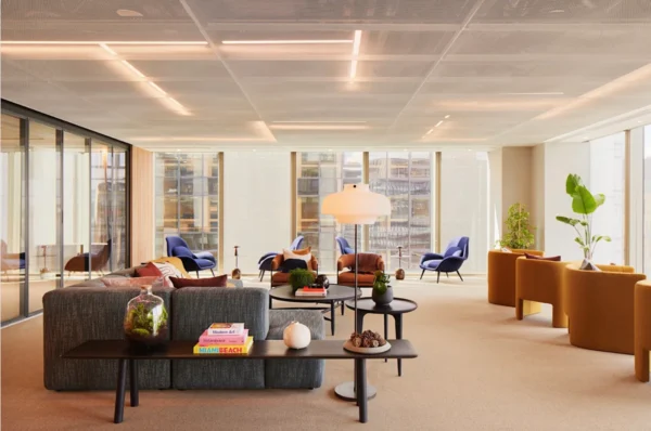 Modern office lounge area with colorful seating and large windows at 69 Old Broad Street, London.