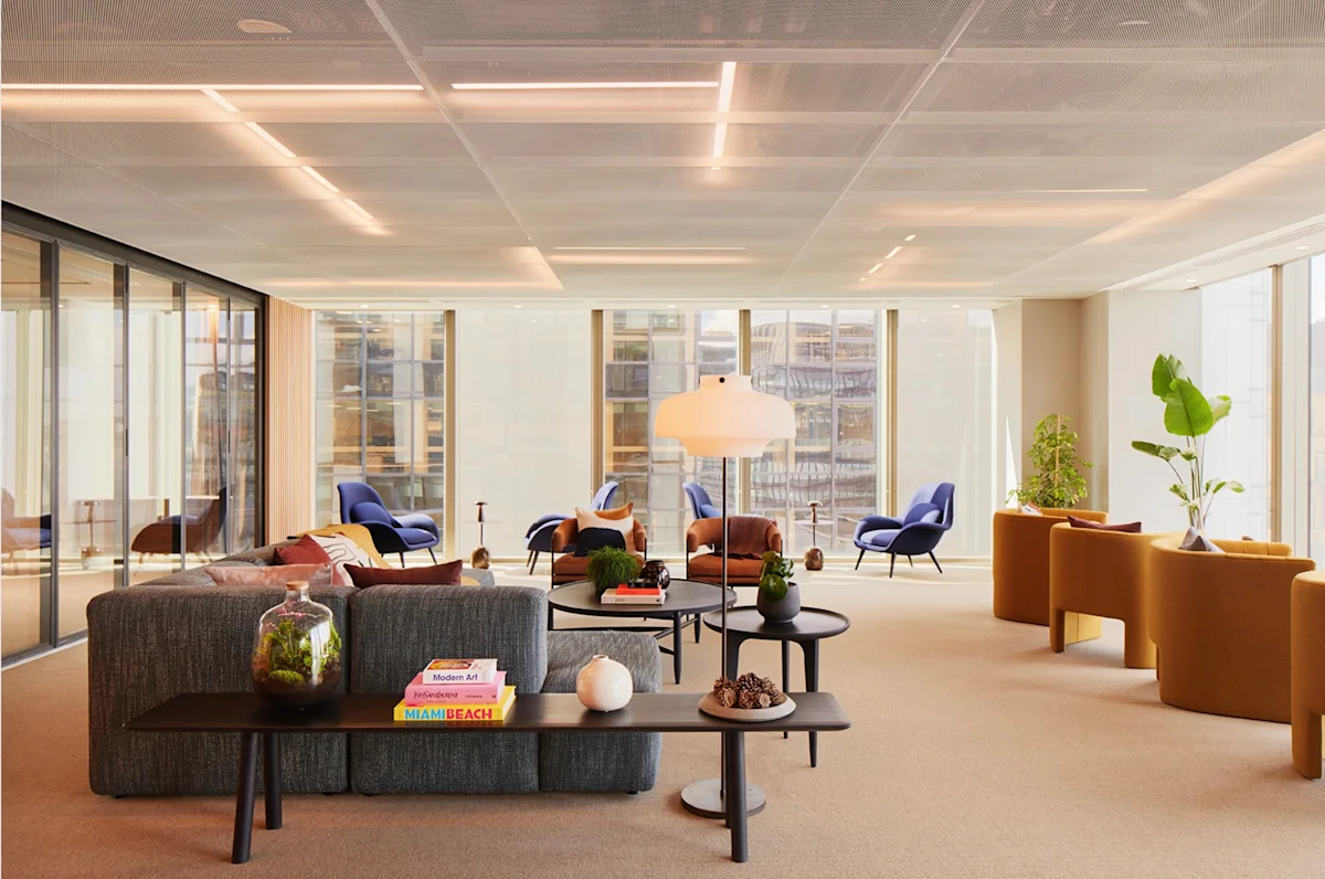 Modern office lounge area with colorful seating and large windows at 69 Old Broad Street, London.