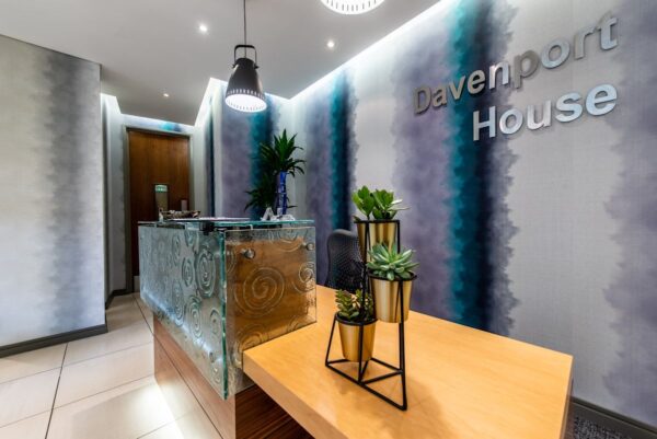 Reception area of Davenport House with modern decor and a plant display.