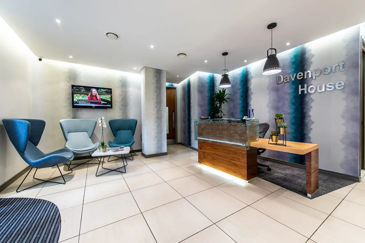 Modern reception area of Davenport House with stylish seating and a decorative front desk.