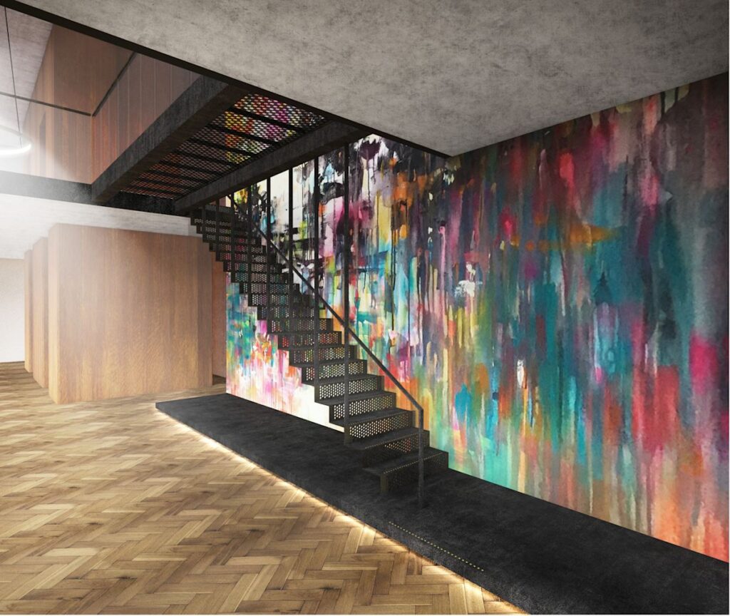 A modern interior features a metal staircase and a vibrant, abstract mural on the wall.