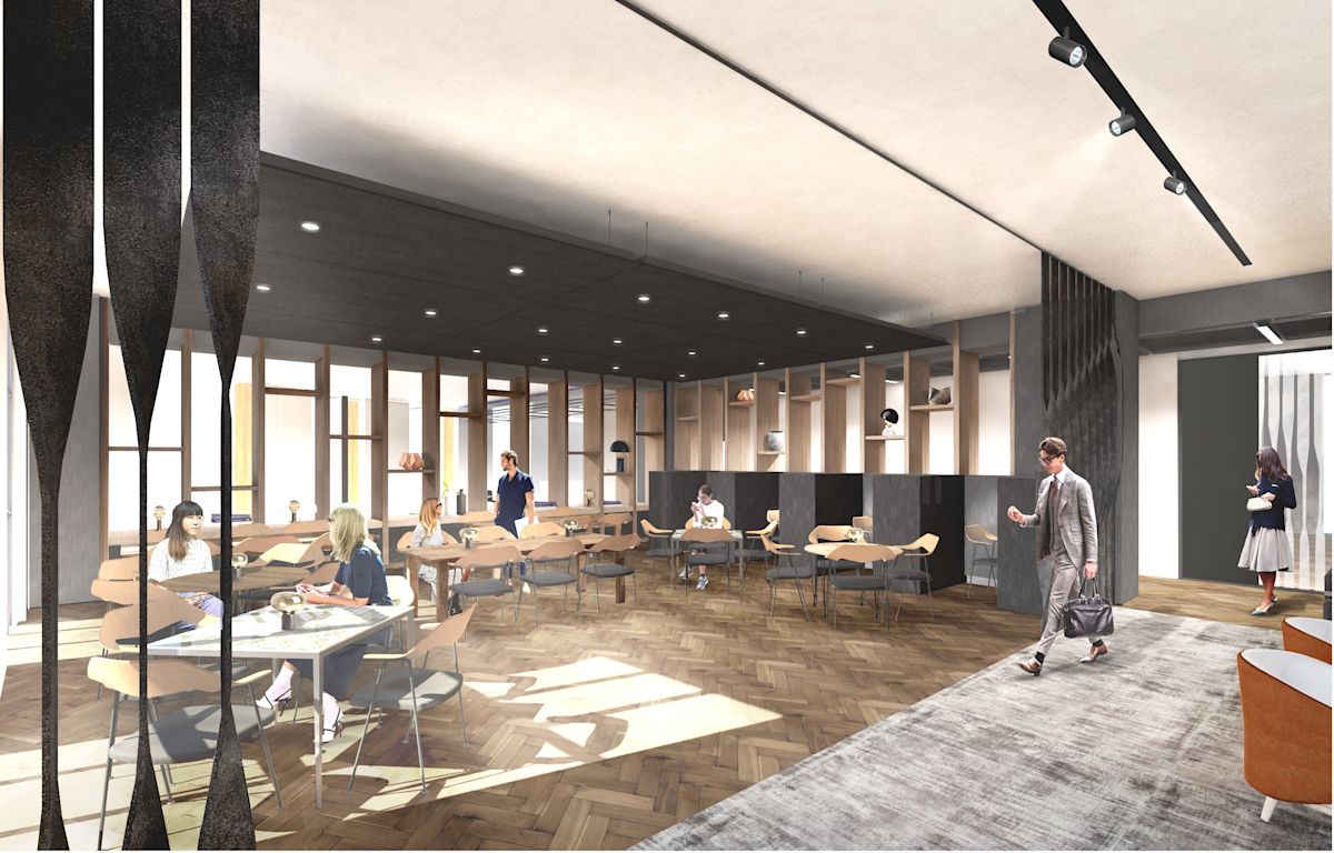 A modern office space with people seated at tables and walking through the area.