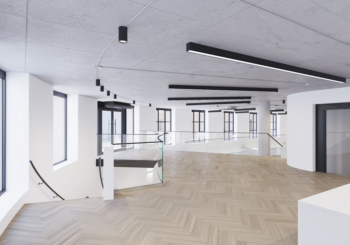 A spacious, modern interior of an office building on Phipp Street in London with large windows, a wooden floor, and sleek lighting fixtures.