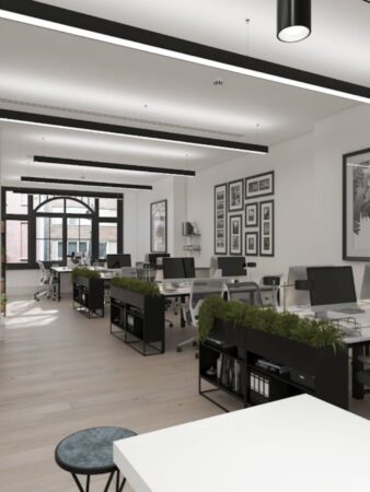 A modern, open-plan office with minimalistic design and natural light on Poland Street, London.