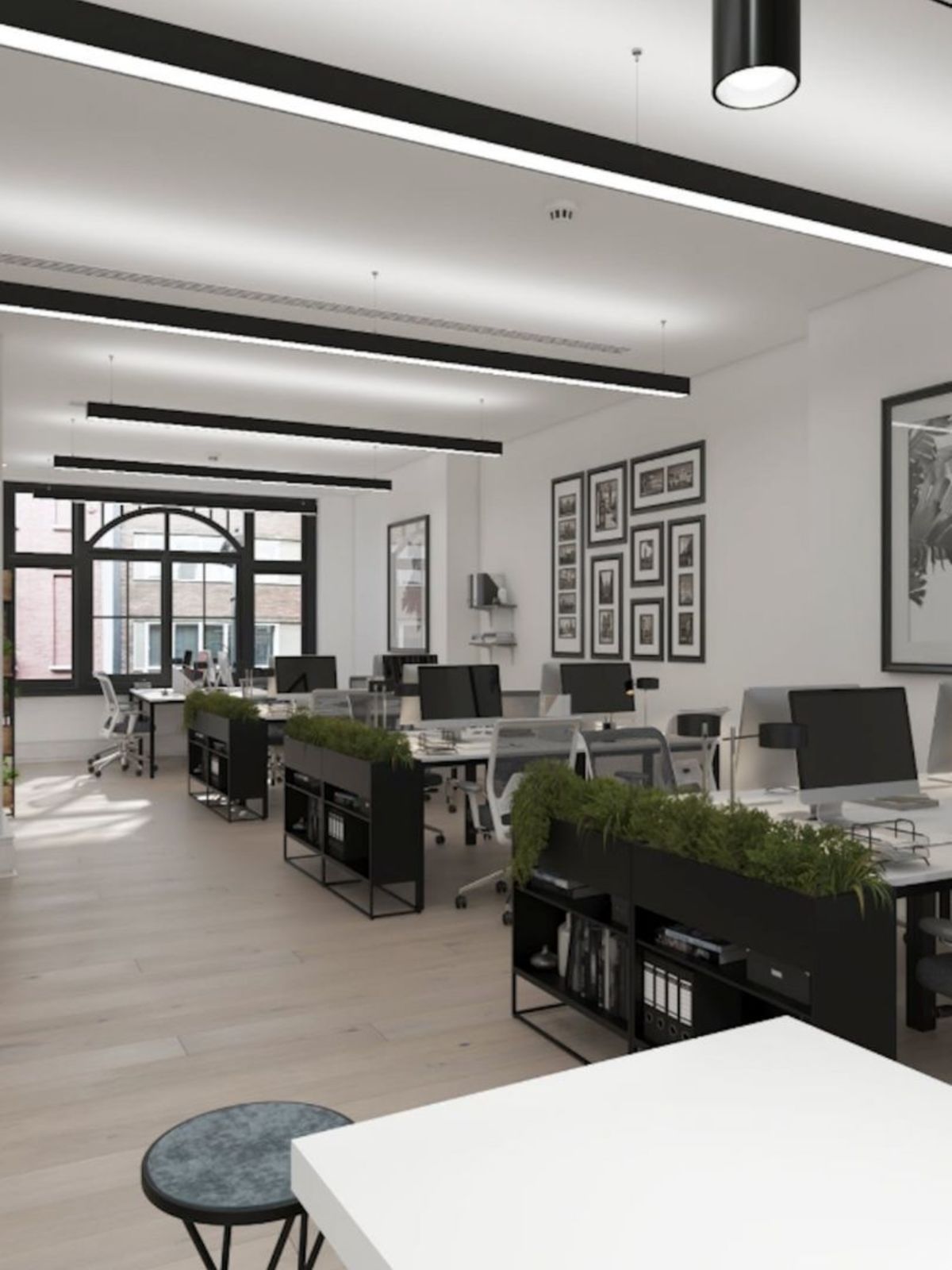 A modern, open-plan office with minimalistic design and natural light on Poland Street, London.