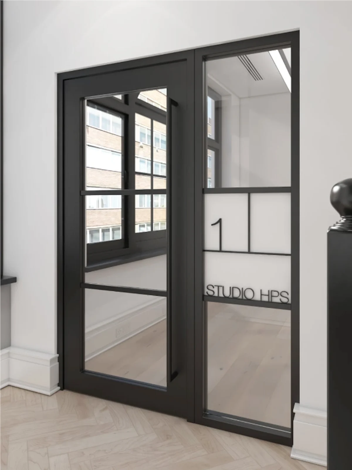 A modern black-framed glass door with "Studio HPS" written on it, inside an office building on Poland Street, London.