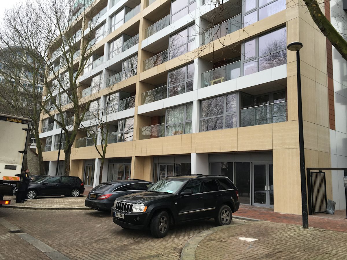 Modern apartment building on Rope Street in London with parked cars in front.