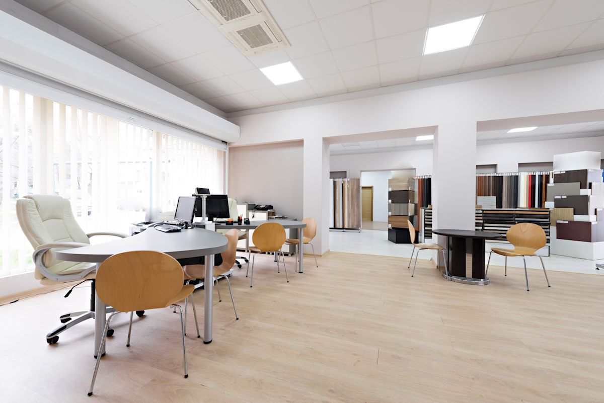 Spacious modern office interior at Scrutton Street, featuring desks, chairs, and computers.