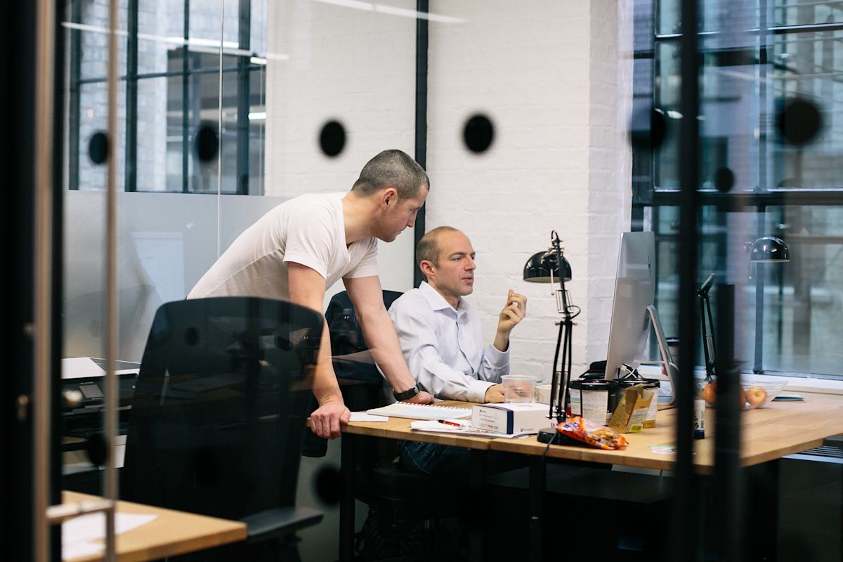 Two men collaborating in a modern office in London.