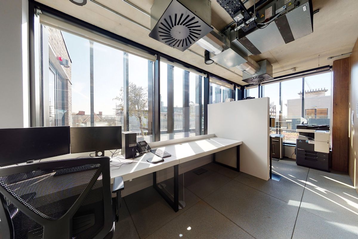 Modern office space at Shoreditch High Street 168 in London with large windows and office equipment.