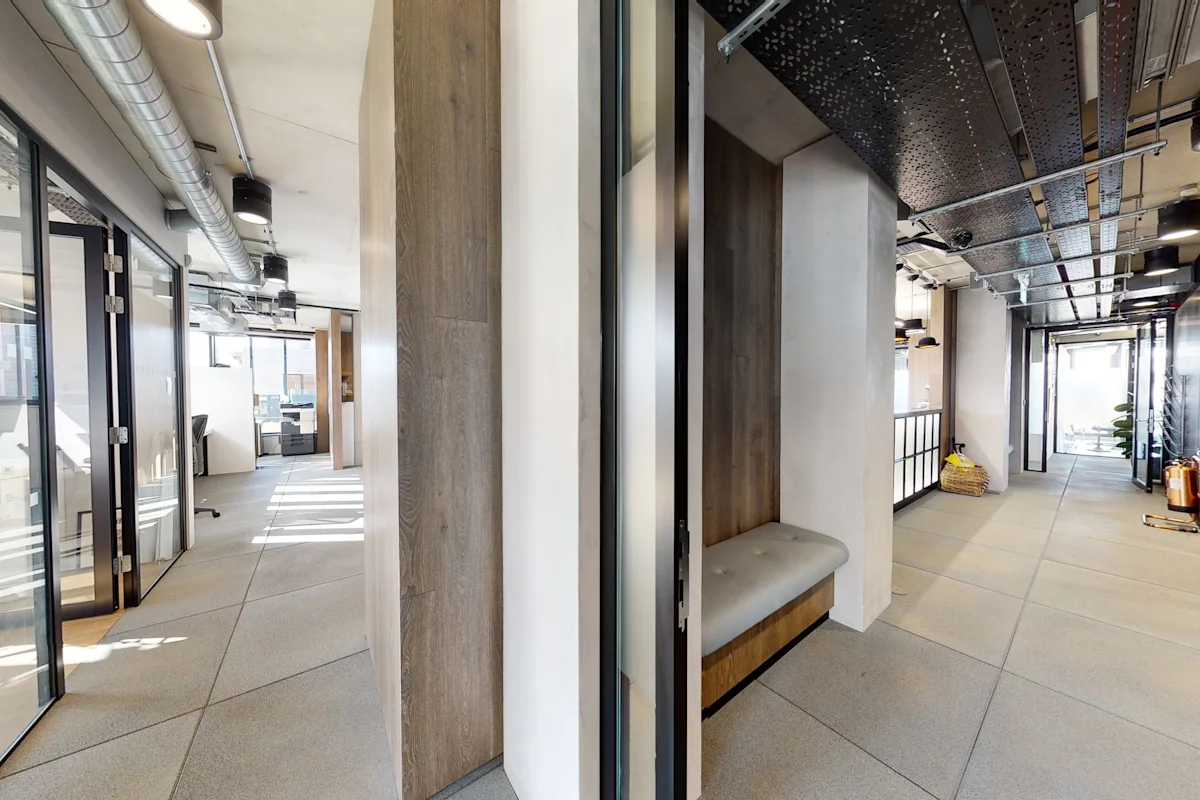 Modern office interior with glass doors and industrial design elements on Shoreditch High Street, London.