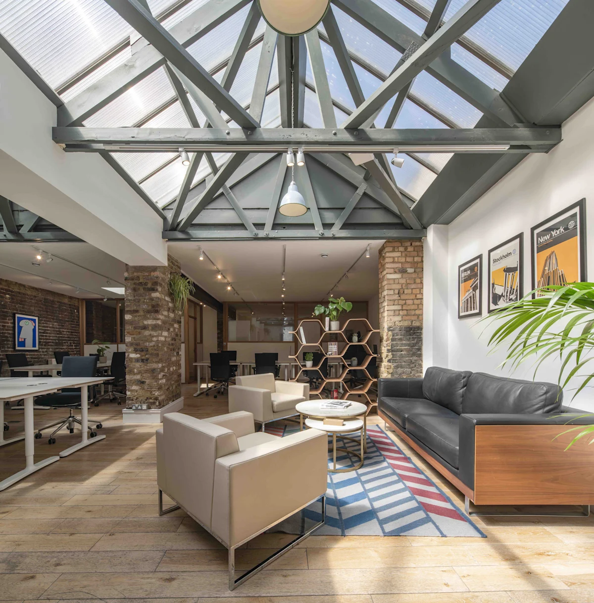 Modern office space with a skylight, lounge chairs, and wooden accents.