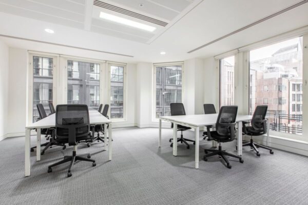 A modern, bright office space with multiple desks and ergonomic chairs at 63 St Mary Axe, London.