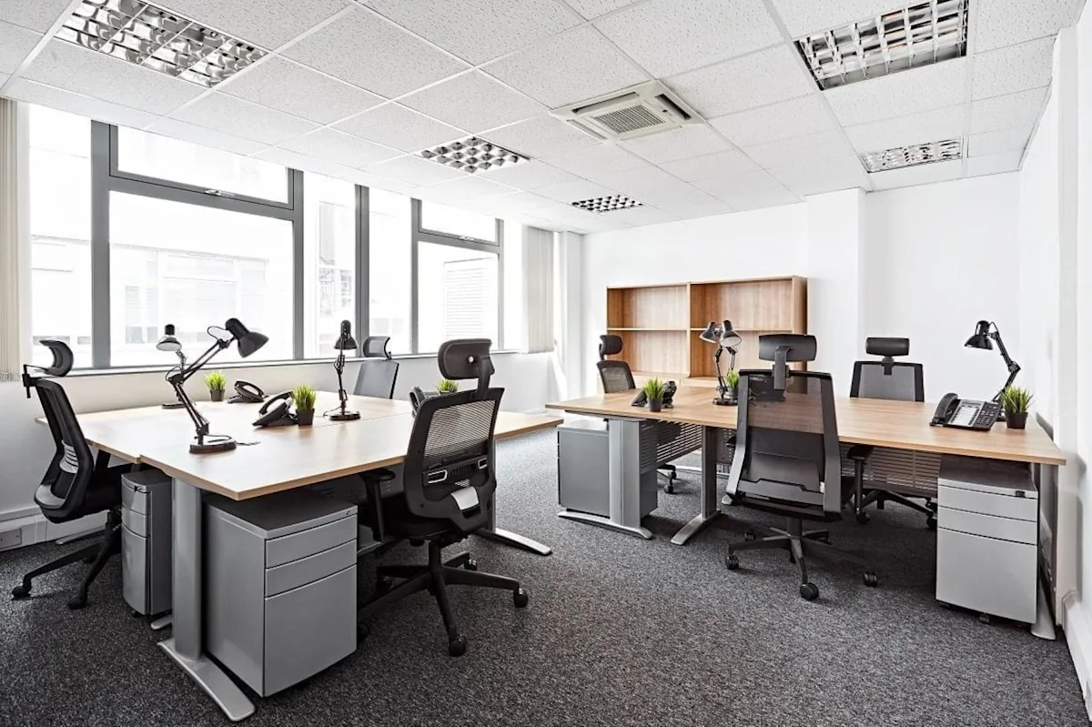 Modern office space with multiple desks and ergonomic chairs at 2-8 Victoria Avenue, London.