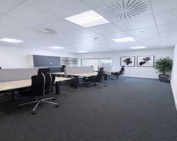 A modern, spacious office interior with several desks, office chairs, and minimalist decor.