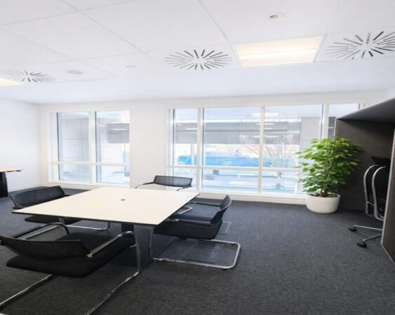 Modern office space at Westferry Circus 11, London, featuring a meeting table, chairs, and large windows.